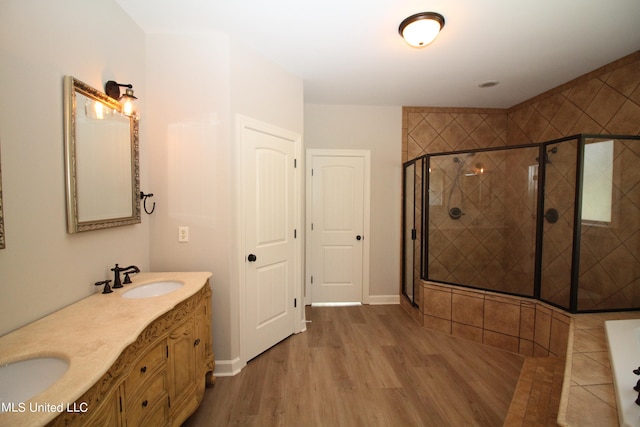 bathroom with vanity, wood-type flooring, and walk in shower