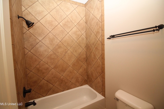 bathroom with toilet and tiled shower / bath combo