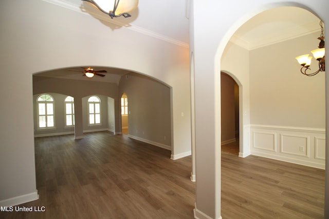 foyer featuring ornamental molding, dark wood-type flooring, and ceiling fan with notable chandelier