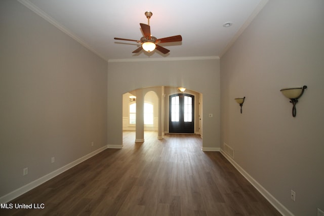 entryway with ornamental molding, ceiling fan, and dark hardwood / wood-style flooring