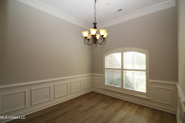 unfurnished room with ornamental molding, a notable chandelier, and dark hardwood / wood-style floors