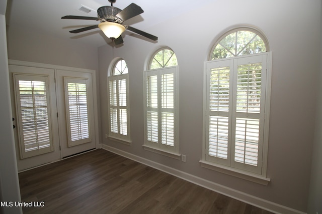 unfurnished sunroom featuring a wealth of natural light and ceiling fan