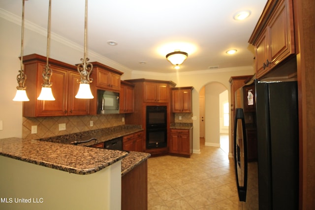 kitchen with dark stone countertops, black appliances, decorative backsplash, and hanging light fixtures