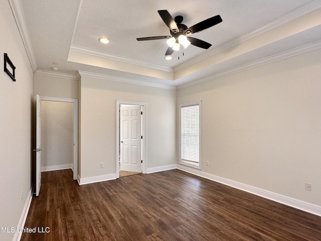 unfurnished bedroom featuring a raised ceiling, baseboards, and dark wood-style flooring