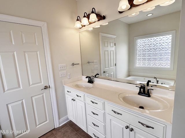 bathroom with tile patterned flooring, double vanity, a washtub, and a sink