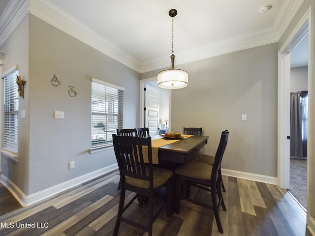 dining room with dark wood-type flooring and ornamental molding