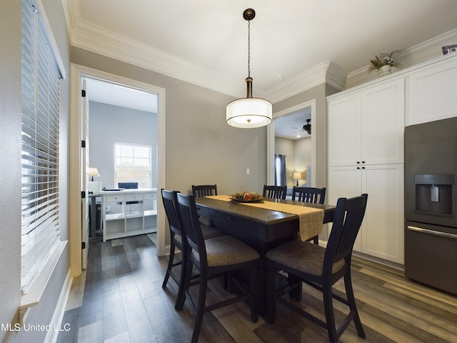 dining space featuring ceiling fan, crown molding, and dark wood-type flooring