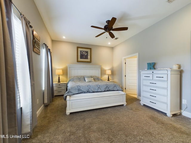 bedroom with ceiling fan and dark colored carpet