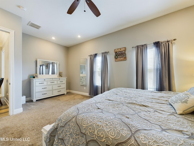 bedroom featuring multiple windows, ceiling fan, and light colored carpet