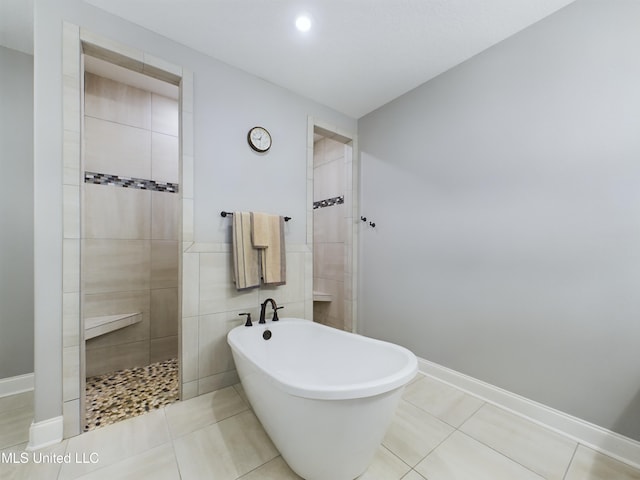 bathroom featuring separate shower and tub and tile patterned flooring