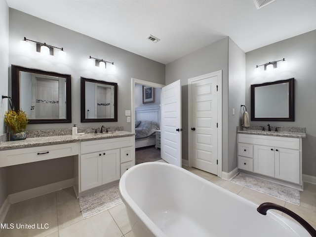 bathroom with tile patterned flooring, vanity, and a bathtub