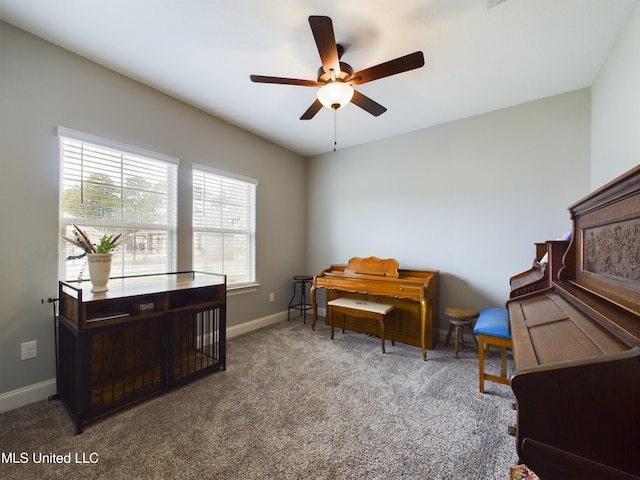 sitting room with ceiling fan and carpet floors