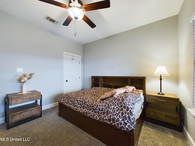 bedroom featuring ceiling fan and dark carpet