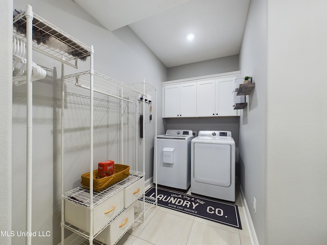 laundry area with washer and clothes dryer, cabinets, and light tile patterned floors