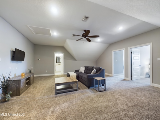 carpeted living room featuring ceiling fan, lofted ceiling, and a textured ceiling