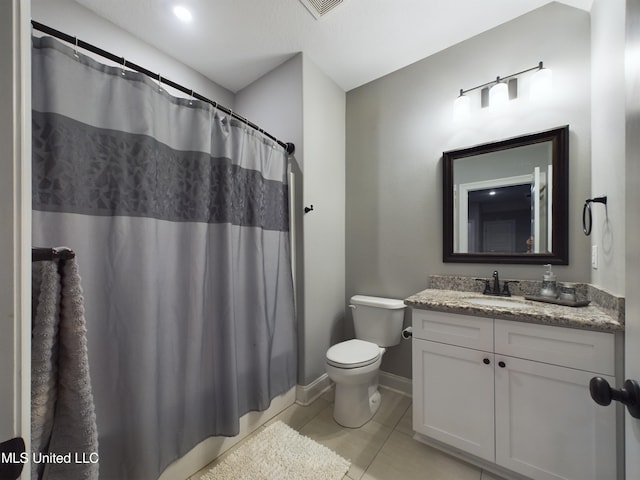 bathroom with toilet, vanity, tile patterned floors, and a shower with shower curtain