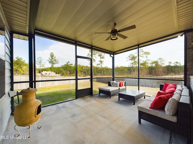 sunroom / solarium featuring ceiling fan and wood ceiling