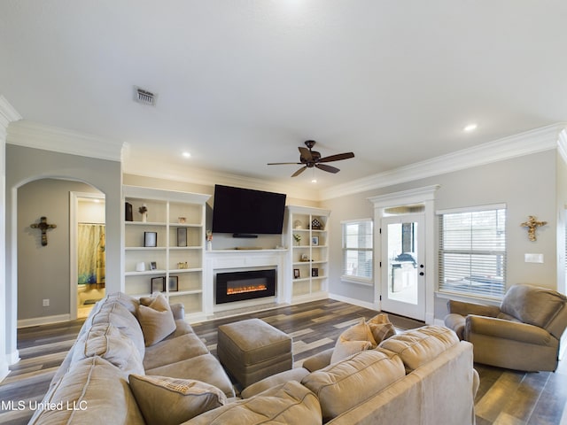 living room with dark hardwood / wood-style floors, ceiling fan, and crown molding