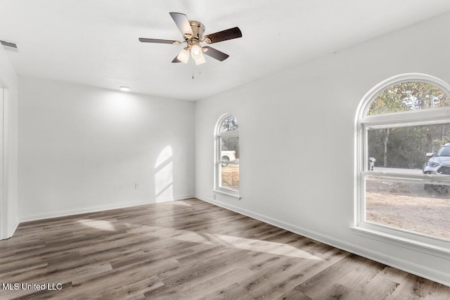 unfurnished room with wood-type flooring and ceiling fan