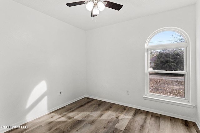 unfurnished room featuring ceiling fan and hardwood / wood-style floors