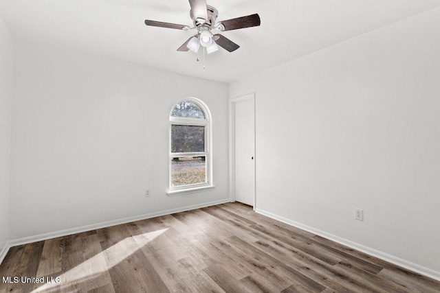 empty room featuring ceiling fan and light wood-type flooring