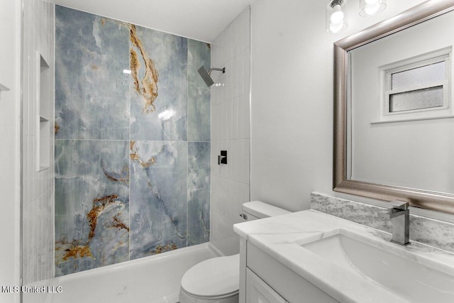 bathroom featuring vanity, toilet, and a tile shower