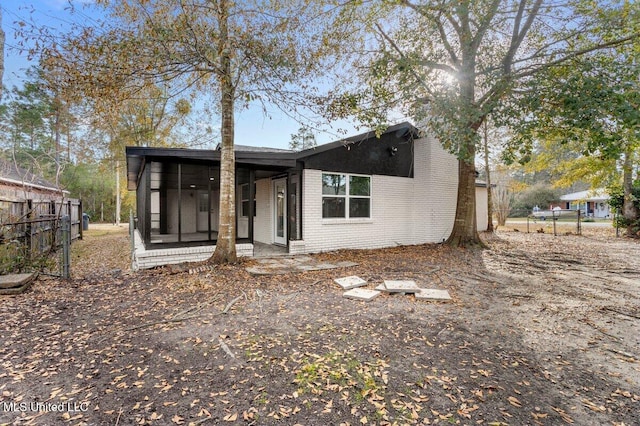 rear view of house with a sunroom