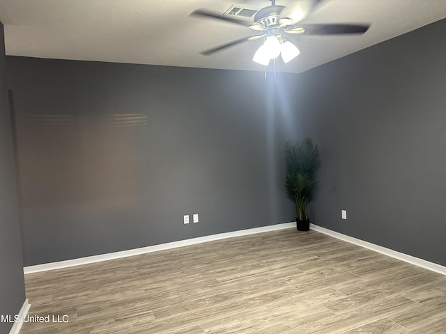 empty room with ceiling fan and light wood-type flooring