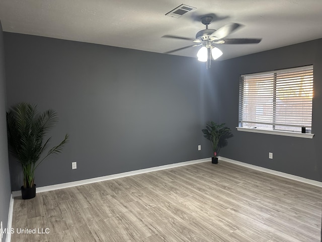 empty room featuring ceiling fan and light hardwood / wood-style flooring