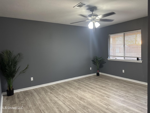 empty room with ceiling fan and light hardwood / wood-style floors