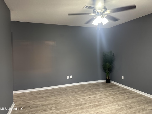 empty room featuring ceiling fan and light wood-type flooring