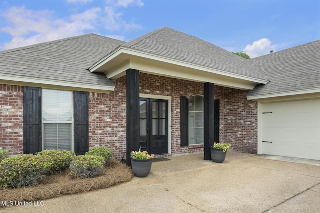 116 Windy Holw, Madison, MS 39110 - entrance to property featuring a garage, french doors, brick siding, and a shingled roof