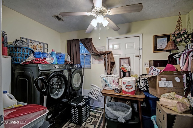 laundry area featuring ceiling fan, washing machine and dryer, and a textured ceiling