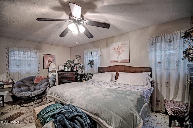 bedroom with a textured ceiling and ceiling fan