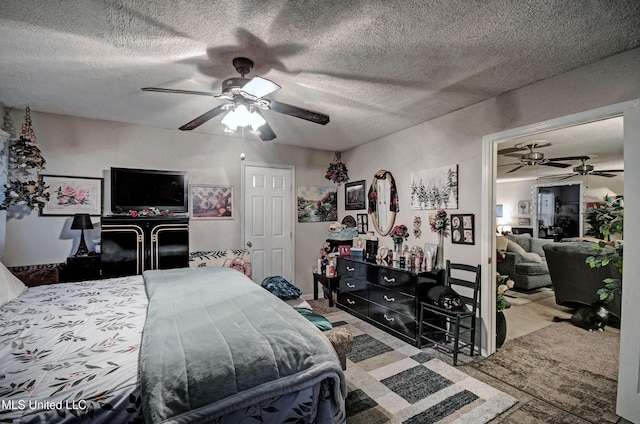 bedroom with ceiling fan and a textured ceiling