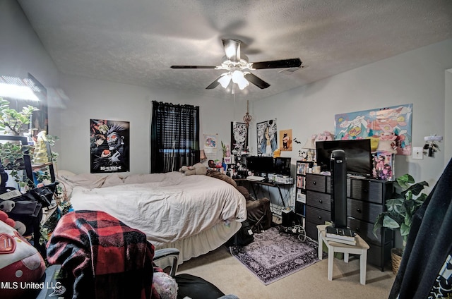 bedroom featuring carpet flooring, a textured ceiling, and ceiling fan