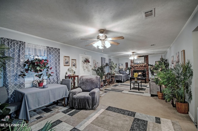 carpeted living room with crown molding, ceiling fan, a fireplace, and a textured ceiling