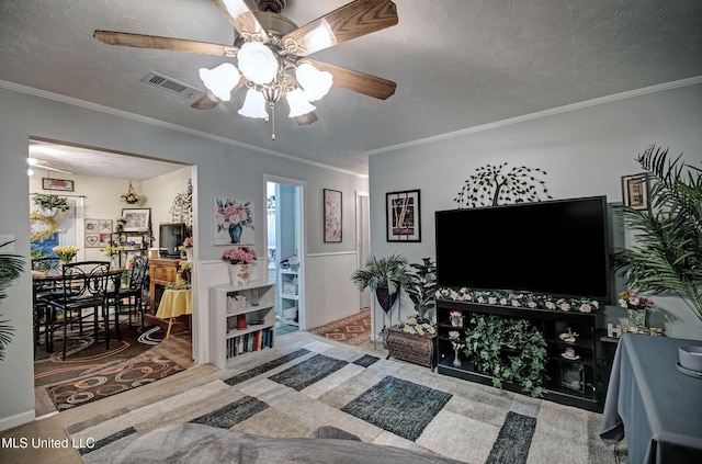 living room with crown molding, carpet flooring, and a textured ceiling