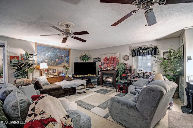 living room featuring ceiling fan and a textured ceiling