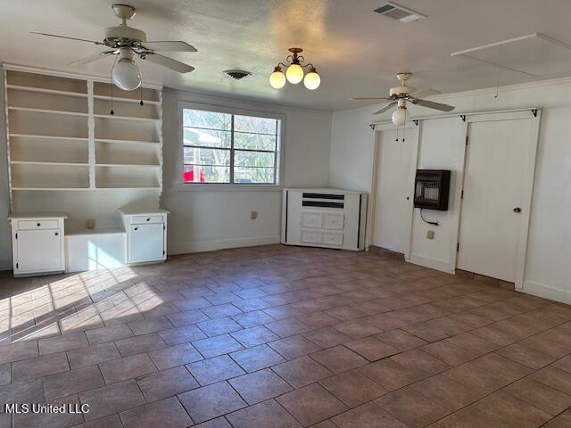 kitchen featuring heating unit, white cabinetry, and ceiling fan