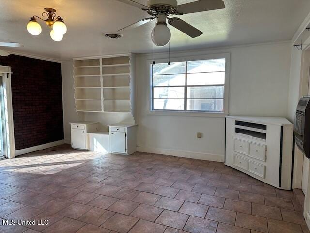 unfurnished bedroom featuring ceiling fan with notable chandelier and crown molding