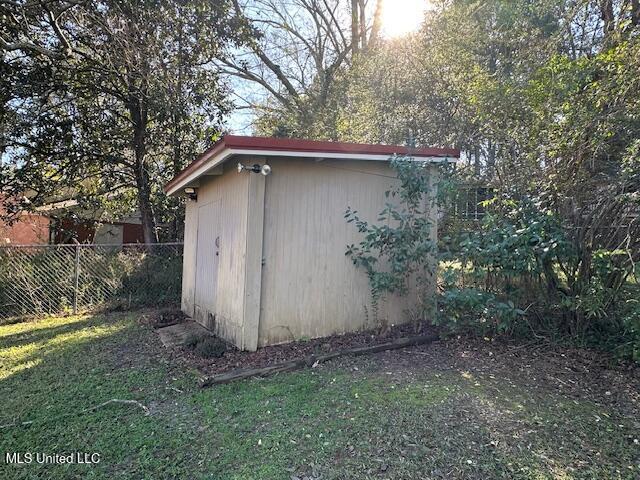 view of outdoor structure with a lawn