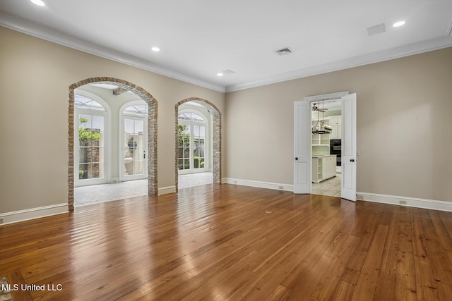 1 Cypress Ln, Jackson, MS 39211 - unfurnished room with hardwood / wood-style flooring, crown molding, arched walkways, and recessed lighting