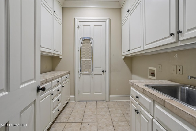 1 Cypress Ln, Jackson, MS 39211 - laundry area featuring washer hookup, cabinet space, and light tile patterned floors