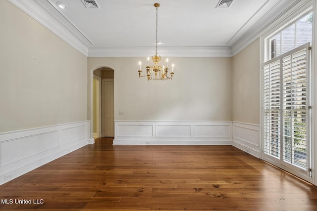 1 Cypress Ln, Jackson, MS 39211 - unfurnished dining area featuring healthy amount of natural light, arched walkways, a chandelier, hardwood / wood-style floors, and a wainscoted wall