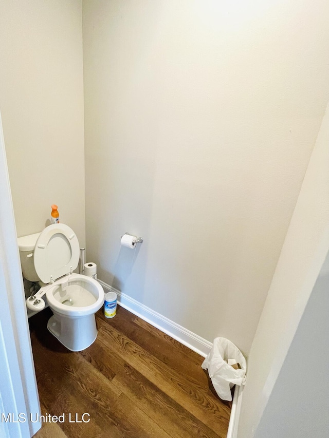 bathroom with toilet and wood finished floors