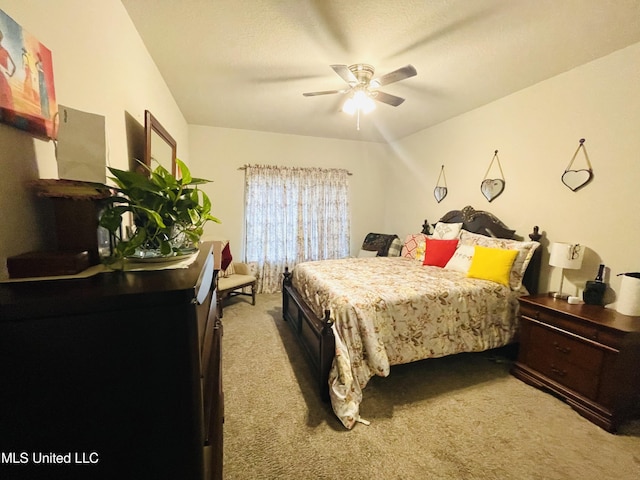 bedroom with a ceiling fan and light colored carpet