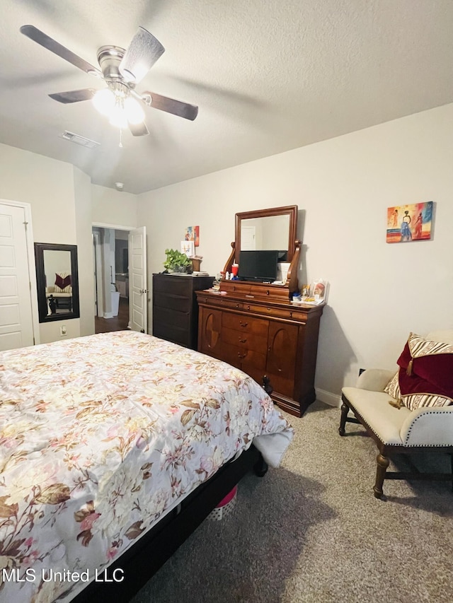 carpeted bedroom with baseboards, visible vents, and ceiling fan