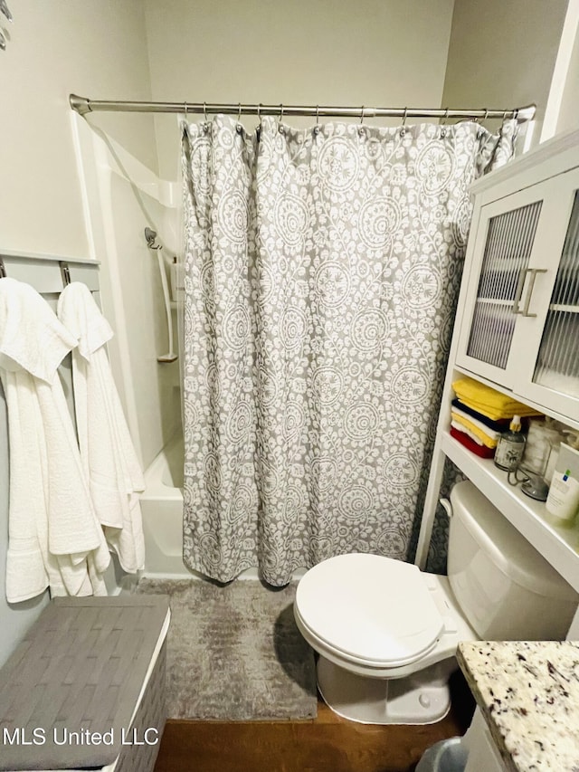 full bathroom with shower / bath combo and toilet