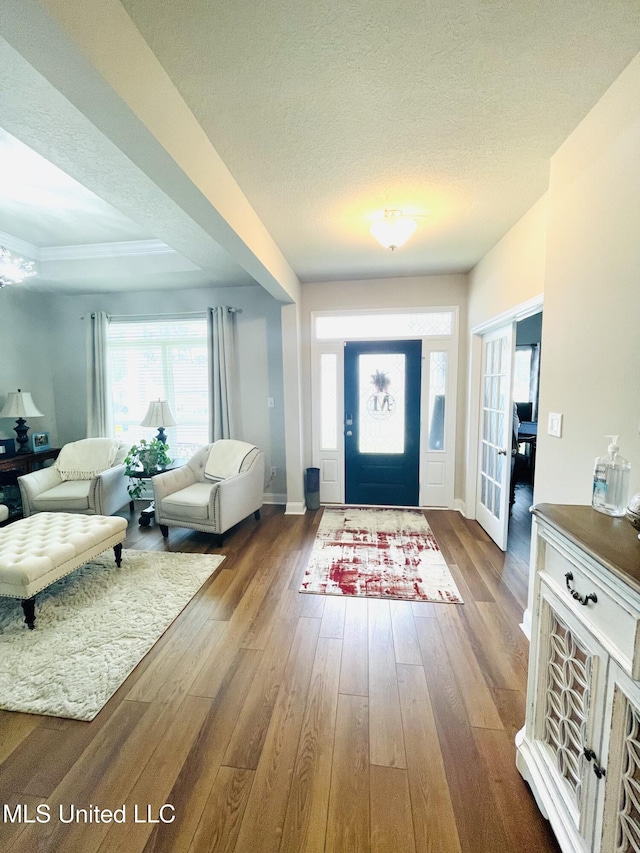 entryway featuring baseboards, wood finished floors, and a wealth of natural light